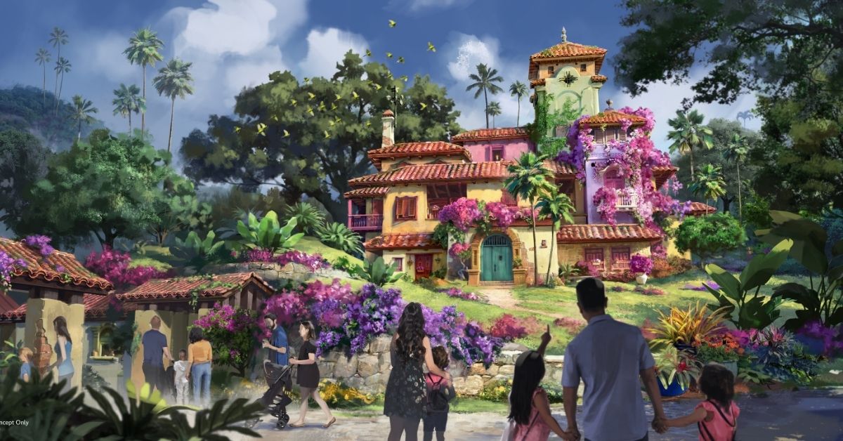 a group of people walking in front of a colorful house